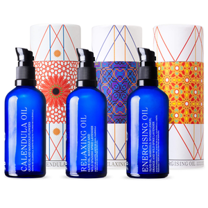 andaluz skincare moisturizing oils calendula, lavender and citrus. three blue bottles with black plastic pumps and three decorative boxes with spanish design